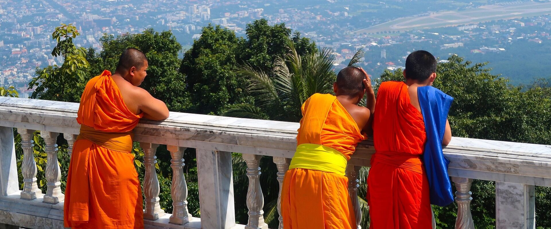 Chiang Rai’s lush hills in Thailand on a Chiang Rai Travel banner by Legend Travel Group.